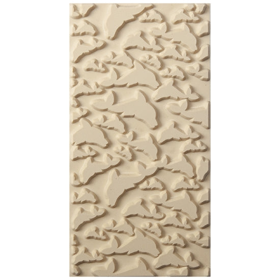 Texture Tile - Flying Dolphins. Beige Texture Tiles are flexible, washable and can be used with any soft clay. Spritz with CoolSlip or dust on Dry Powder Release for stick-free impressions when using metal clay and polymer clay.