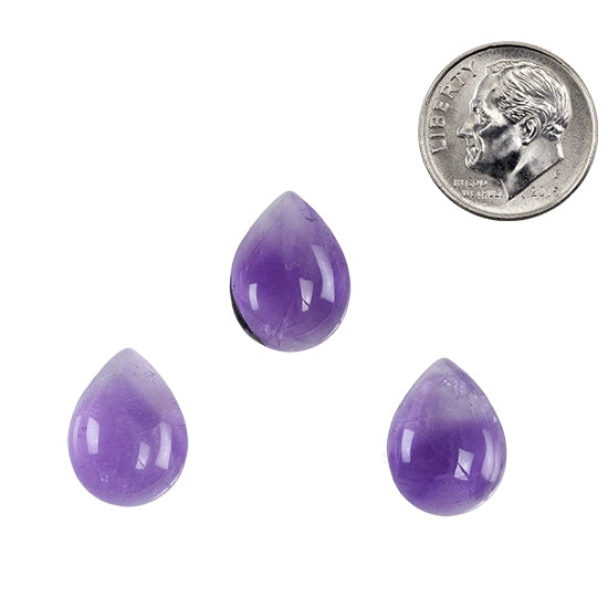 group of three Cabochon Pear Amethyst Gemstones with dime